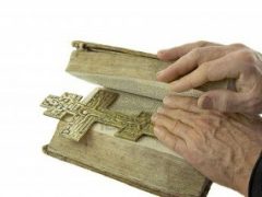 4661363-male-hand-closed-the-vintage-bible-with-cross-on-it-isolated-over-white-background